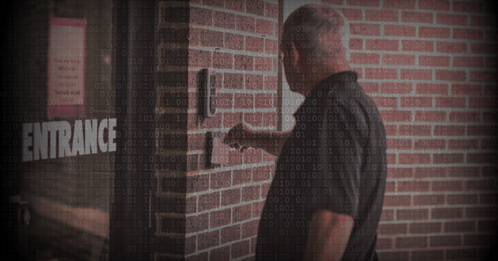 Access control credentials being used by a man outside building