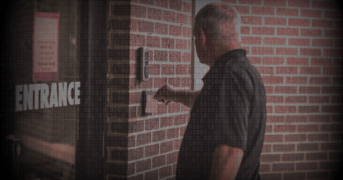Access control credentials being used by a man outside building